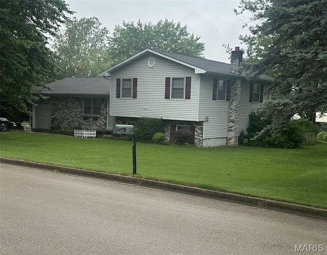 1301 Camillia St, Farmington, MO 63640 - view of front of home featuring a chimney and a front yard