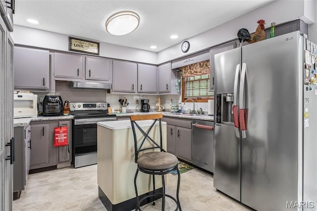 1301 Camillia St, Farmington, MO 63640 - kitchen with stainless steel appliances, ventilation hood, gray cabinetry, and recessed lighting