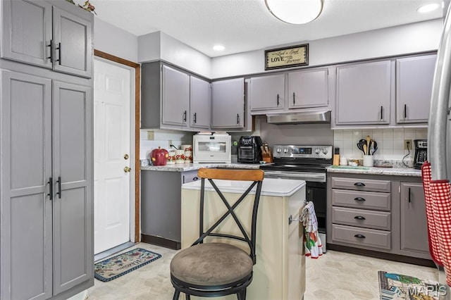 1301 Camillia St, Farmington, MO 63640 - kitchen featuring gray cabinetry, extractor fan, electric range, decorative backsplash, and light floors