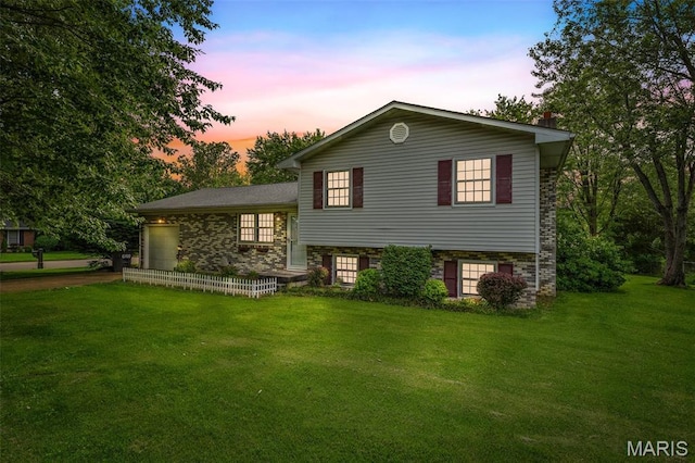 1301 Camillia St, Farmington, MO 63640 - view of front facade with a yard, concrete driveway, and an attached garage