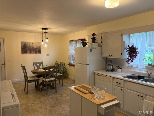 422 W Dover St, Monroe City, MO 63456 - kitchen with white appliances, hanging light fixtures, washer / clothes dryer, and white cabinetry