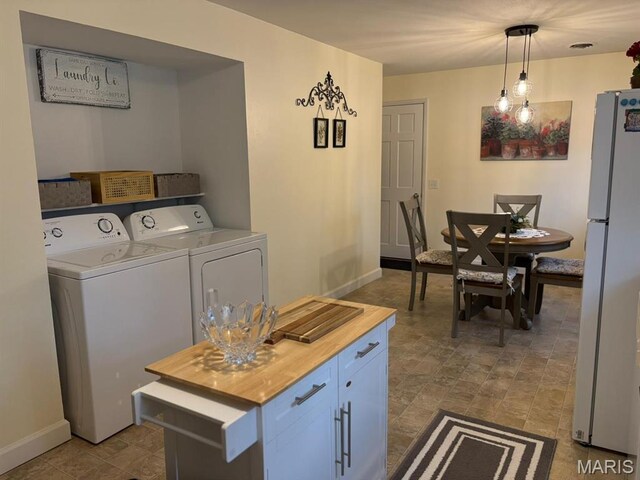422 W Dover St, Monroe City, MO 63456 - kitchen with freestanding refrigerator, separate washer and dryer, butcher block counters, and pendant lighting
