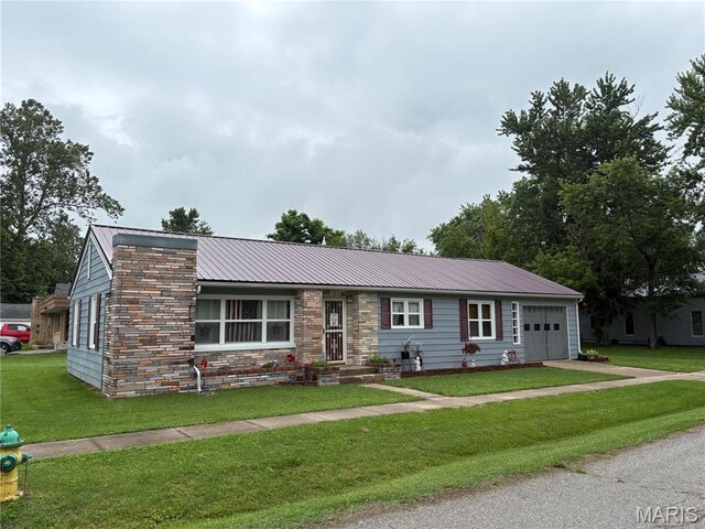 422 W Dover St, Monroe City, MO 63456 - single story home with an attached garage, a metal roof, a front yard, driveway, and stone siding