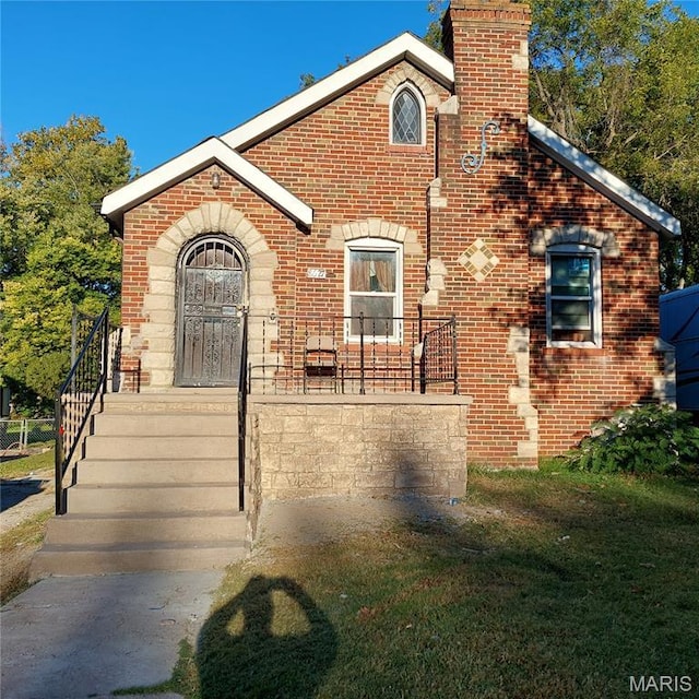 8627 Park Ln, Saint Louis, MO 63147 - view of front facade featuring brick siding and a chimney