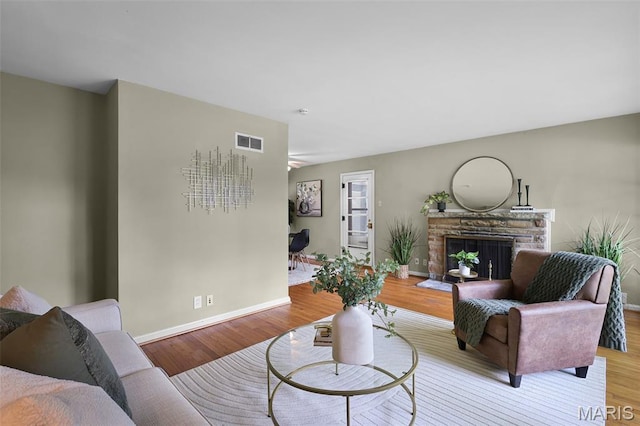 450 Forest Green Dr, Webster Groves, MO 63119 - living area with a fireplace with raised hearth and wood finished floors