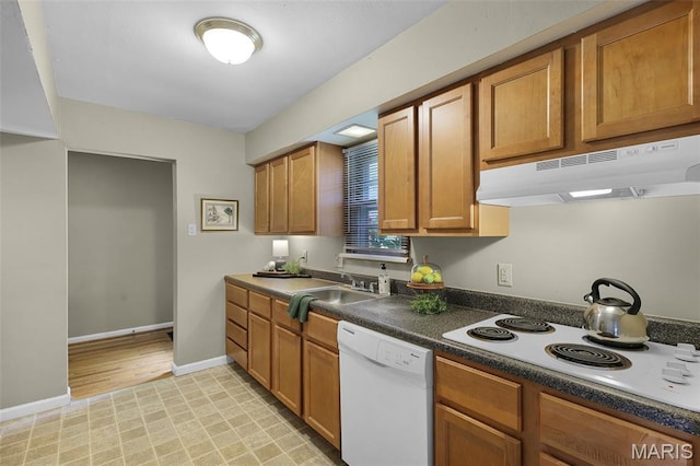 450 Forest Green Dr, Webster Groves, MO 63119 - kitchen with white appliances, under cabinet range hood, brown cabinets, and dark countertops