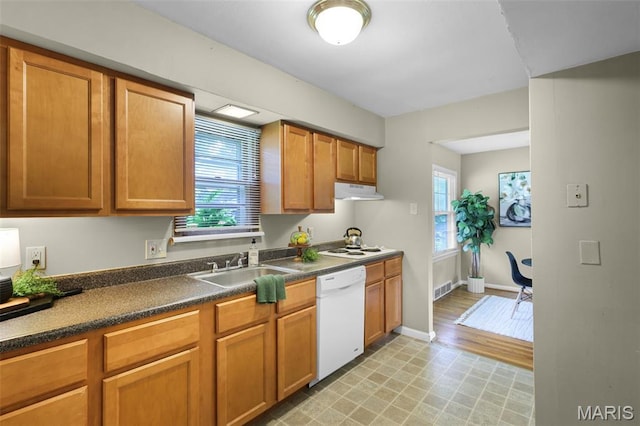 450 Forest Green Dr, Webster Groves, MO 63119 - kitchen featuring white dishwasher, dark countertops, under cabinet range hood, and brown cabinetry