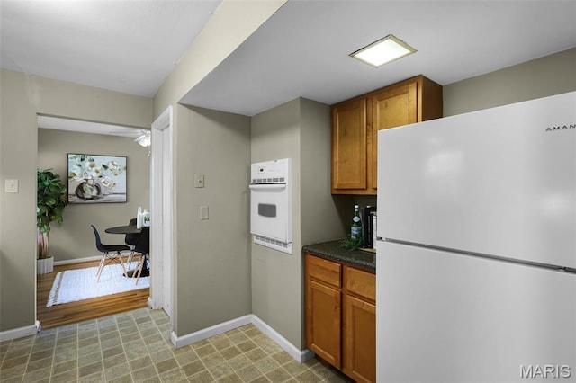 450 Forest Green Dr, Webster Groves, MO 63119 - kitchen featuring white appliances, dark countertops, brown cabinetry, and ceiling fan