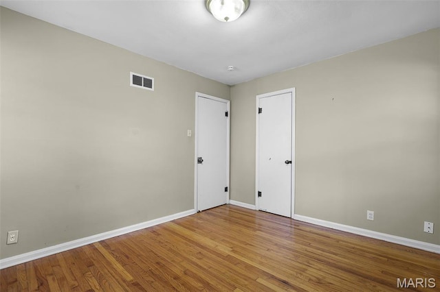 450 Forest Green Dr, Webster Groves, MO 63119 - unfurnished bedroom featuring baseboards and wood finished floors