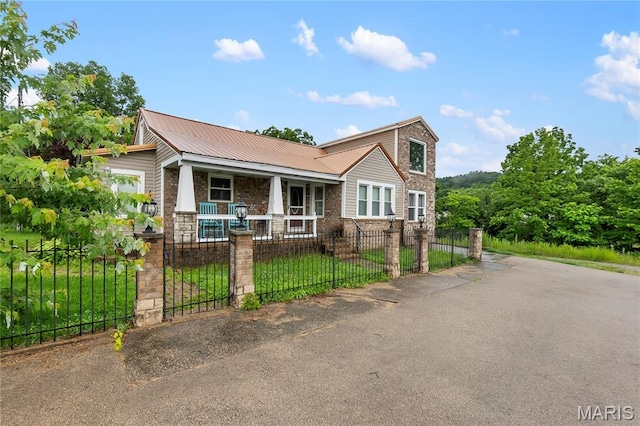 115 Whitener St, Marquand, MO 63655 - view of front of home featuring a porch, a fenced front yard, a metal roof, and a gate