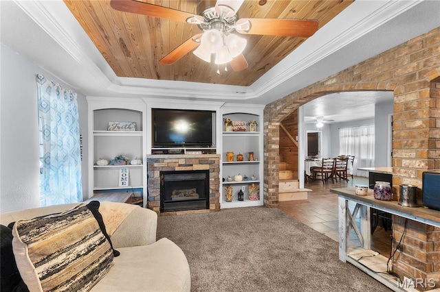 115 Whitener St, Marquand, MO 63655 - carpeted living area featuring ceiling fan, a raised ceiling, wood ceiling, built in shelves, and a fireplace