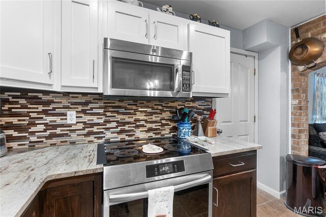 115 Whitener St, Marquand, MO 63655 - kitchen with appliances with stainless steel finishes, tasteful backsplash, and white cabinets