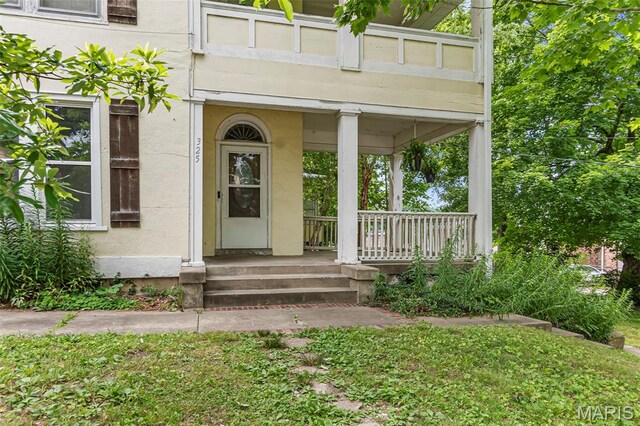 325 N Lorimier St, Cape Girardeau, MO 63701 - view of exterior entry with covered porch and stucco siding
