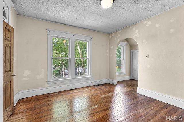 325 N Lorimier St, Cape Girardeau, MO 63701 - empty room featuring hardwood / wood-style floors and arched walkways