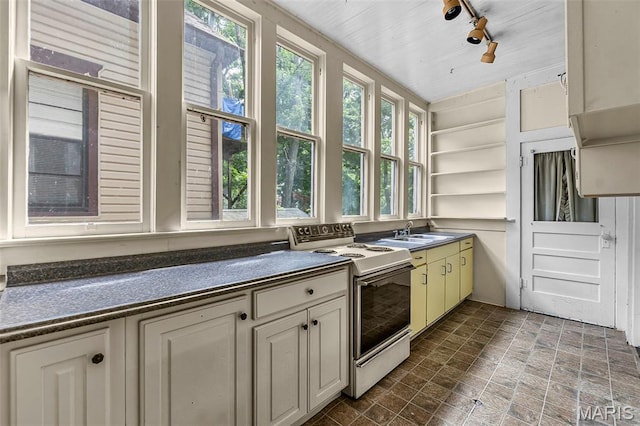 325 N Lorimier St, Cape Girardeau, MO 63701 - kitchen featuring electric range, dark countertops, open shelves, cream cabinetry, and track lighting