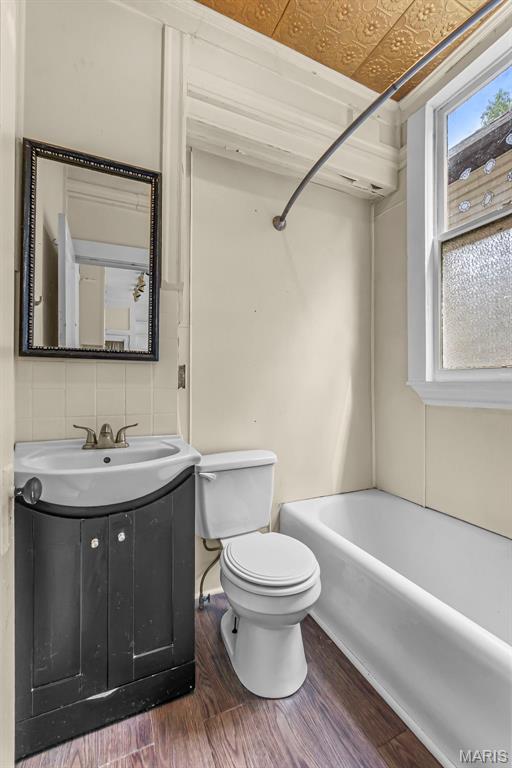 325 N Lorimier St, Cape Girardeau, MO 63701 - full bathroom featuring vanity, wood finished floors, an ornate ceiling, and shower / tub combination