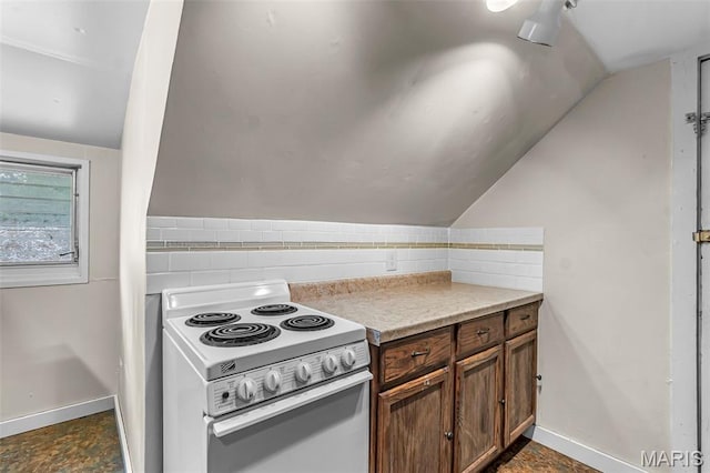 325 N Lorimier St, Cape Girardeau, MO 63701 - kitchen featuring white electric stove, lofted ceiling, backsplash, and light countertops