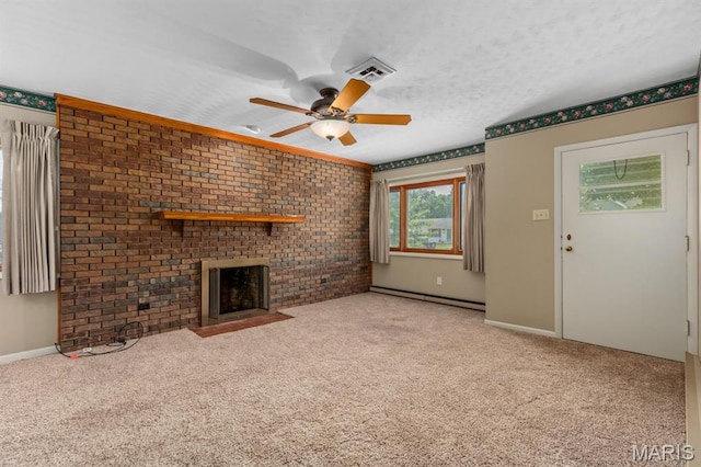201 E Old Route 66, Mount Olive, IL 62069 - unfurnished living room featuring a baseboard radiator, a ceiling fan, a fireplace, carpet flooring, and brick wall