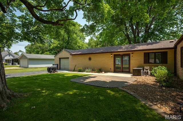 201 E Old Route 66, Mount Olive, IL 62069 - back of house with brick siding, a lawn, and a garage