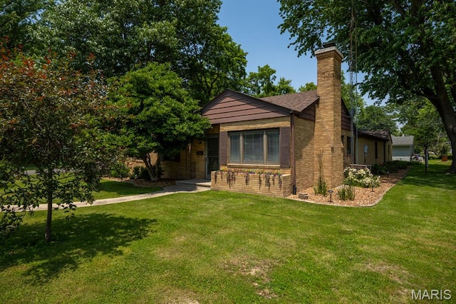 201 E Old Route 66, Mount Olive, IL 62069 - view of front of home with a chimney, a front yard, and brick siding