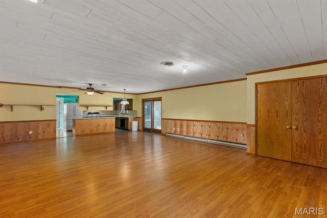 201 E Old Route 66, Mount Olive, IL 62069 - unfurnished living room with a baseboard radiator, light wood-style floors, wainscoting, ornamental molding, and wood walls