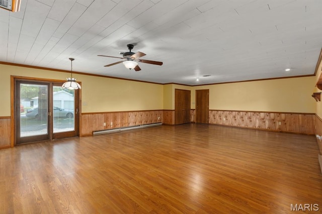 201 E Old Route 66, Mount Olive, IL 62069 - unfurnished room featuring baseboard heating, a wainscoted wall, wood finished floors, crown molding, and wooden walls