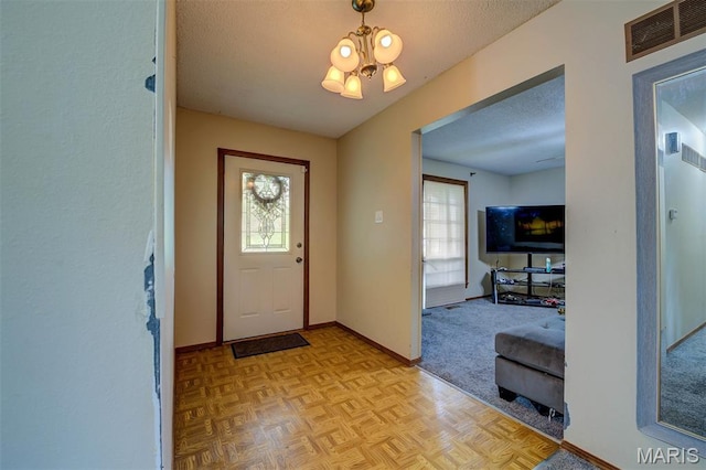 6048 La Chateau Ct, Saint Louis, MO 63129 - entrance foyer featuring a chandelier, plenty of natural light, and a textured ceiling