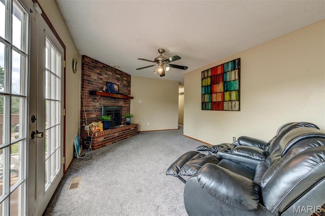 6048 La Chateau Ct, Saint Louis, MO 63129 - carpeted living room featuring ceiling fan and a brick fireplace