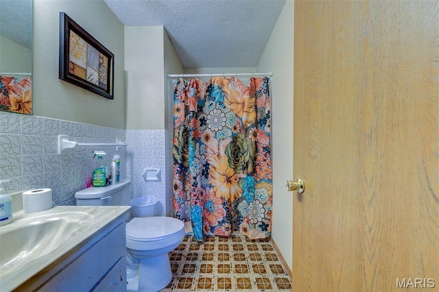 6048 La Chateau Ct, Saint Louis, MO 63129 - full bath with tile walls, a textured ceiling, vanity, tile patterned floors, and curtained shower