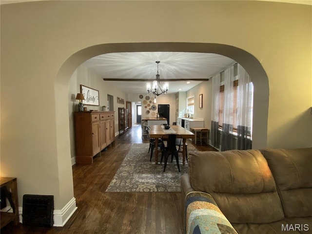 218 W 6th St, Hermann, MO 65041 - dining area with dark wood-style floors, a chandelier, and arched walkways