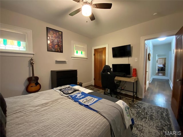 218 W 6th St, Hermann, MO 65041 - bedroom with wood finished floors, a ceiling fan, and a desk