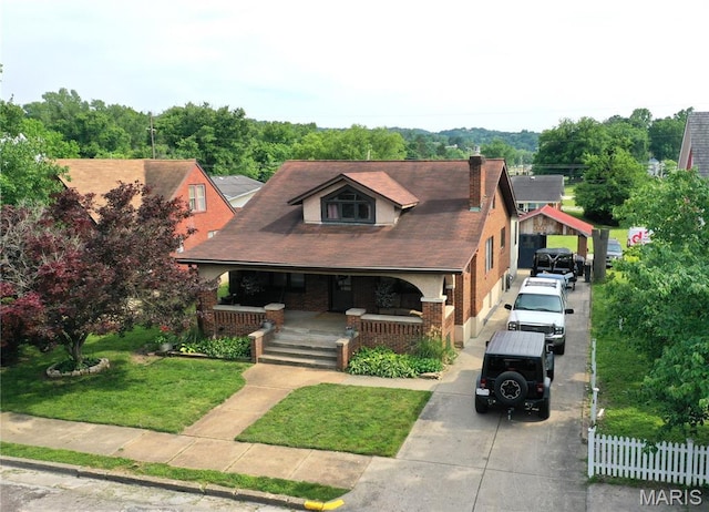 218 W 6th St, Hermann, MO 65041 - bungalow featuring a porch, driveway, brick siding, and a chimney
