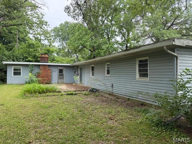 207 Hunter St, Lebanon, IL 62254 - rear view of house featuring a yard and a chimney