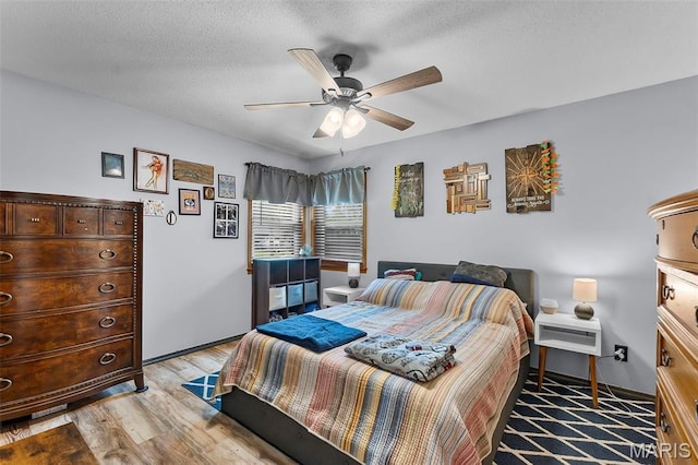 1802 Old Cape Rd, Jackson, MO 63755 - bedroom with light wood-style floors, a ceiling fan, and a textured ceiling