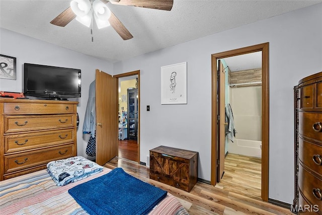 1802 Old Cape Rd, Jackson, MO 63755 - bedroom featuring light wood finished floors, a textured ceiling, and a ceiling fan