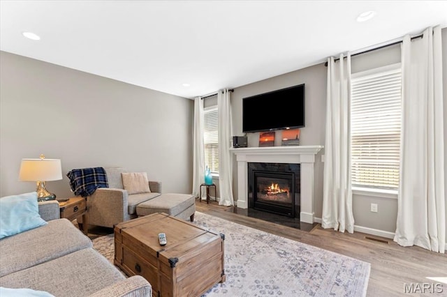 2333 Cabric Dr, Saint Charles, MO 63301 - living area featuring a fireplace with flush hearth, wood finished floors, and recessed lighting
