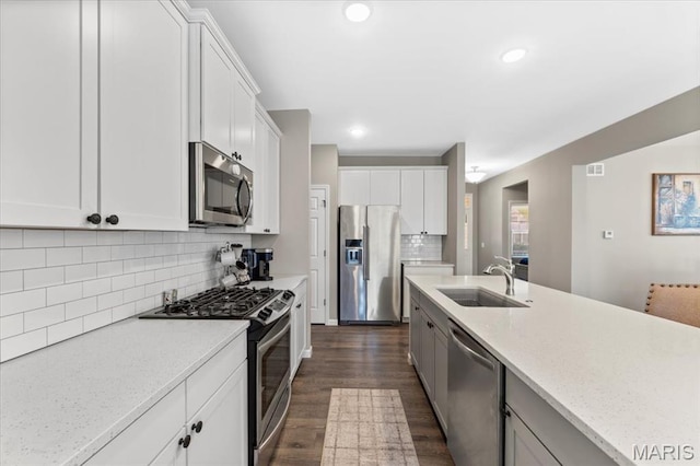 2333 Cabric Dr, Saint Charles, MO 63301 - kitchen with stainless steel appliances, dark wood-type flooring, decorative backsplash, white cabinetry, and light stone countertops