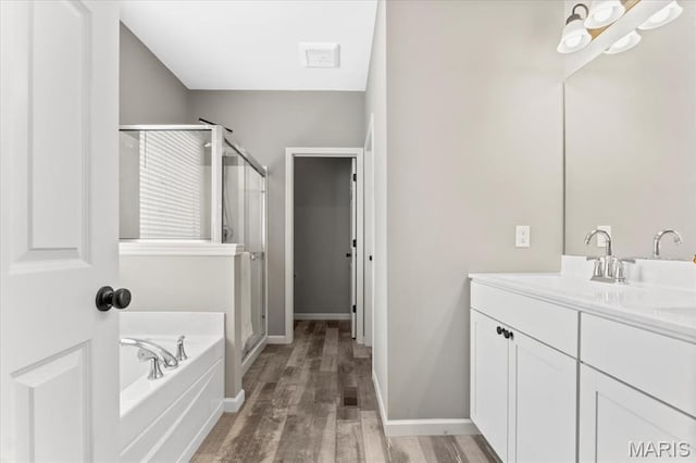 2333 Cabric Dr, Saint Charles, MO 63301 - full bath with a shower stall, vanity, a garden tub, and wood finished floors