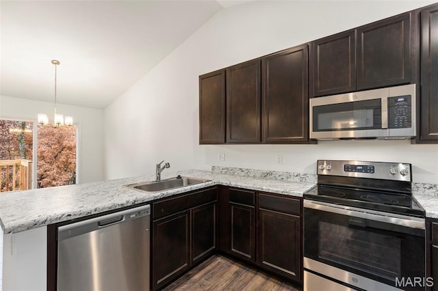 262 Liberty Valley Dr, Foristell, MO 63348 - kitchen with appliances with stainless steel finishes, vaulted ceiling, a peninsula, dark wood-style flooring, and dark brown cabinets