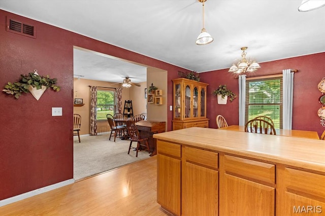 334 Hazel Ave, Belleville, IL 62223 - kitchen featuring light countertops, hanging light fixtures, a chandelier, light wood-style floors, and ceiling fan