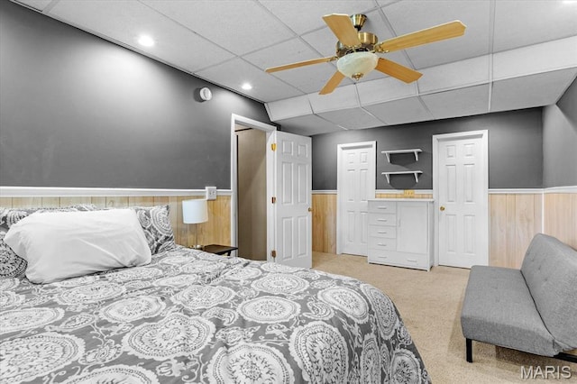 334 Hazel Ave, Belleville, IL 62223 - carpeted bedroom with a wainscoted wall, a drop ceiling, wooden walls, and ceiling fan