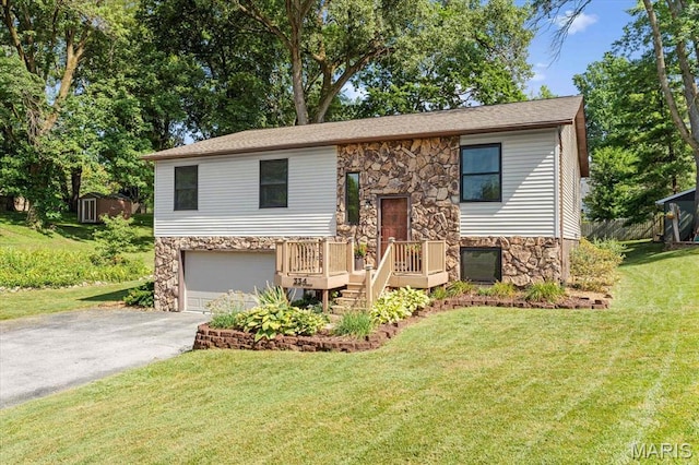 334 Hazel Ave, Belleville, IL 62223 - raised ranch featuring stone siding, driveway, an attached garage, a front lawn, and a deck