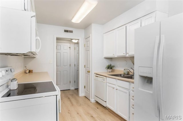 1924 Greenglen Dr Unit 102, Kirkwood, MO 63122 - kitchen featuring white appliances, light wood finished floors, white cabinetry, and light countertops