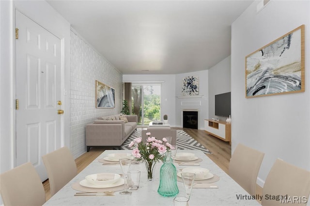1924 Greenglen Dr Unit 102, Kirkwood, MO 63122 - dining space with light wood finished floors and a fireplace