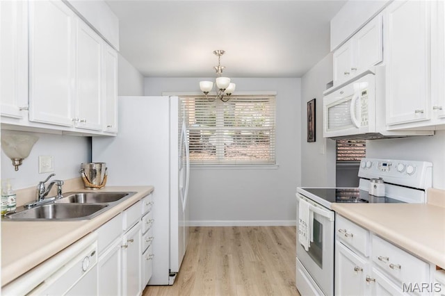 1924 Greenglen Dr Unit 102, Kirkwood, MO 63122 - kitchen featuring white appliances, a chandelier, white cabinetry, and light wood finished floors