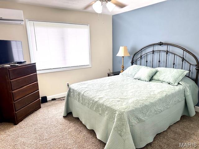 256 Black Oak Trl, Jackson, MO 63755 - bedroom with a wall unit AC, light colored carpet, and a ceiling fan