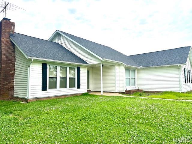 256 Black Oak Trl, Jackson, MO 63755 - rear view of house featuring a chimney, a yard, and roof with shingles
