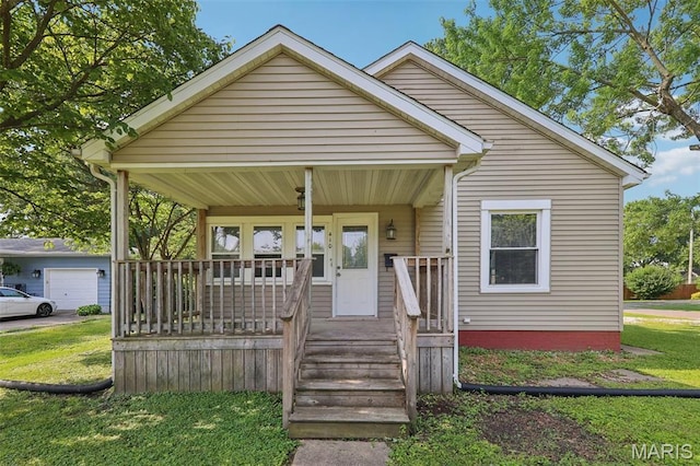 410 W Easton St, Gillespie, IL 62033 - bungalow-style house with a porch, a front lawn, and a garage