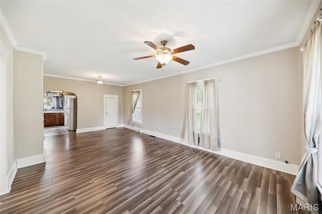 410 W Easton St, Gillespie, IL 62033 - unfurnished living room with arched walkways, a ceiling fan, dark wood-type flooring, and crown molding