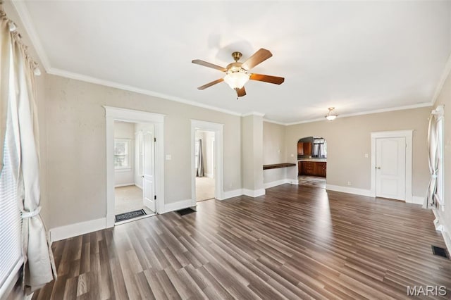 410 W Easton St, Gillespie, IL 62033 - unfurnished living room with arched walkways, a ceiling fan, wood finished floors, and ornamental molding